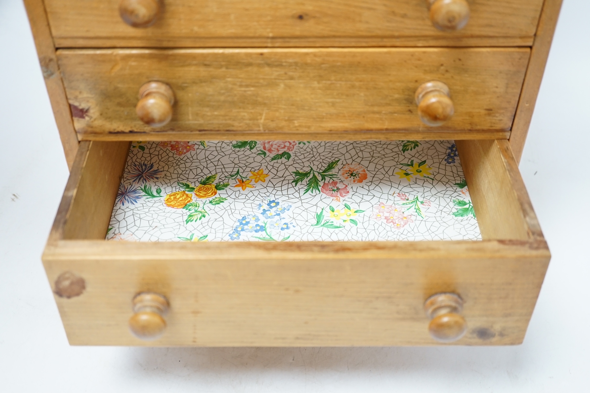 A pine miniature four drawer chest, 33cm high. Condition - poor to fair
